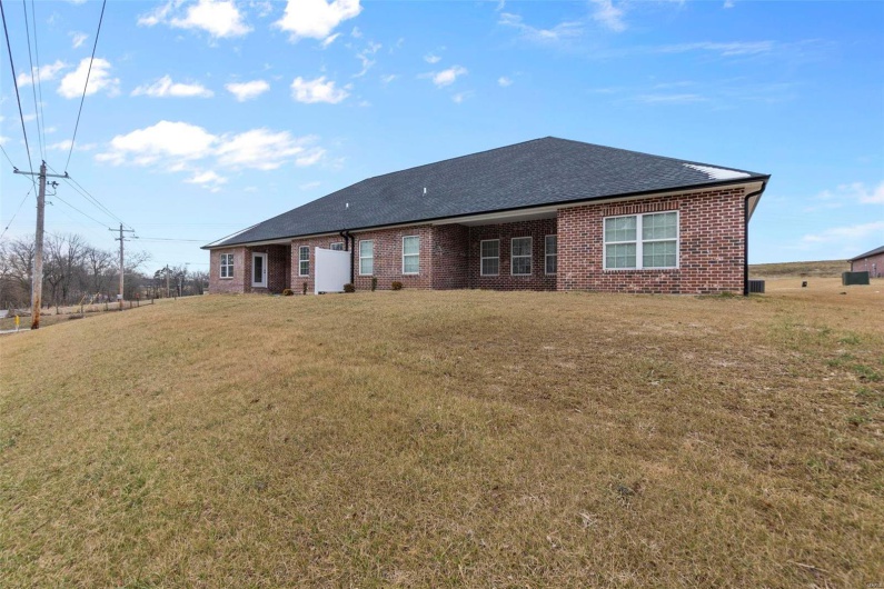 Back of property with a yard