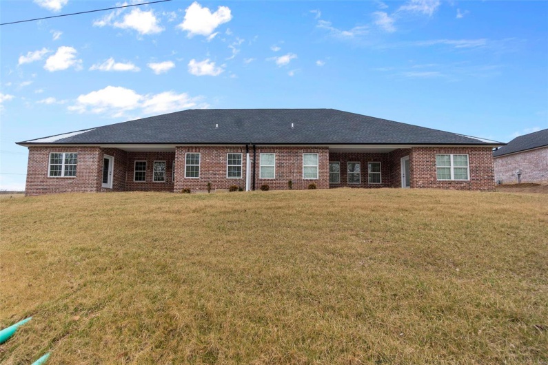 Rear view of property featuring a yard