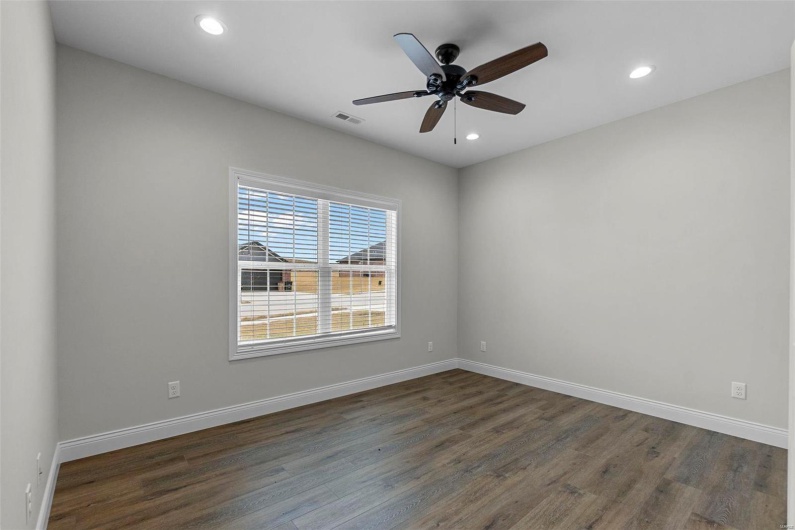 Spare room featuring ceiling fan and dark hardwood / wood-style flooring