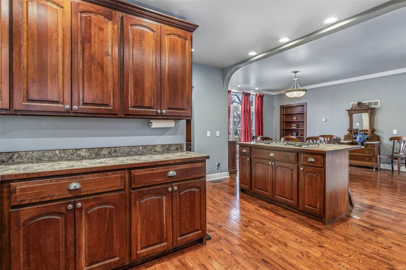 Kitchen featuring hardwood / wood-style floors and crown molding