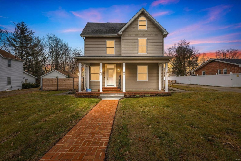 View of front of home featuring a lawn and a porch