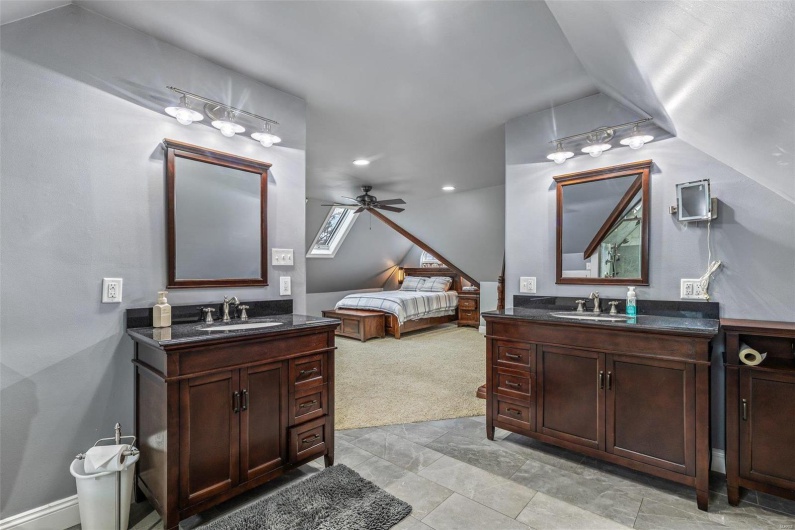 Bathroom with vanity, lofted ceiling, and ceiling fan