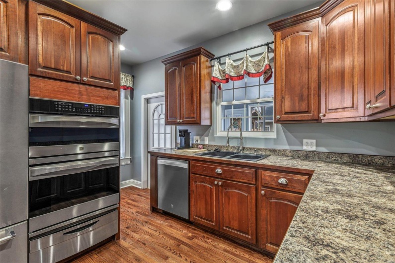 Kitchen with sink, stainless steel appliances, and dark hardwood / wood-style floors