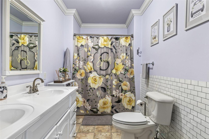 Bathroom with crown molding, vanity, toilet, and a shower with curtain