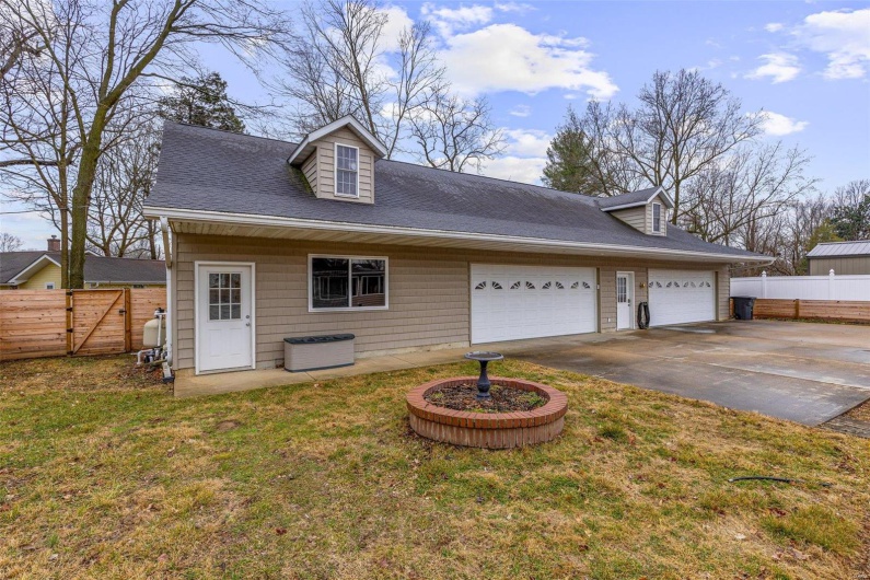 Cape cod house featuring a garage and a front lawn