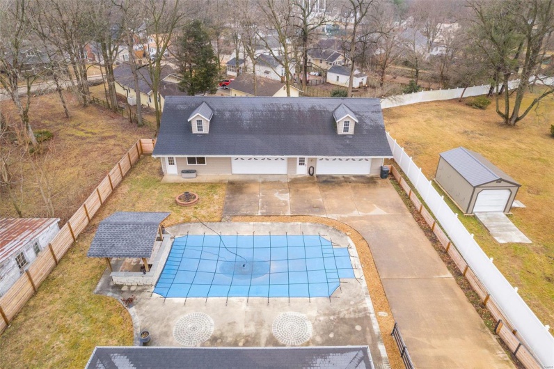 View of swimming pool featuring a patio, a yard, and an outdoor fire pit