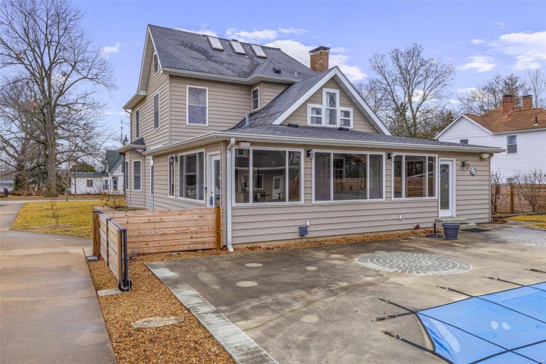 View of back of house with a sunroom and a patio