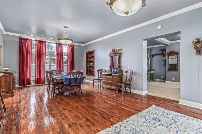 Dining area with crown molding and hardwood / wood-style floors