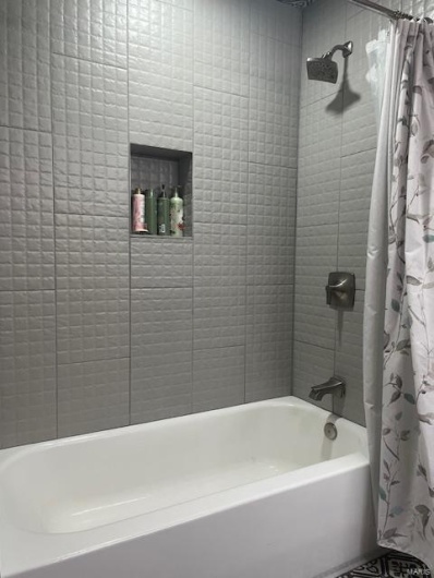 Bathroom with shower / bath combination with curtain