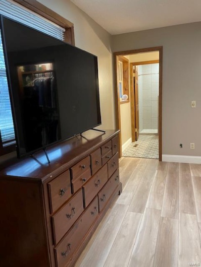 Bedroom with light hardwood / wood-style floors