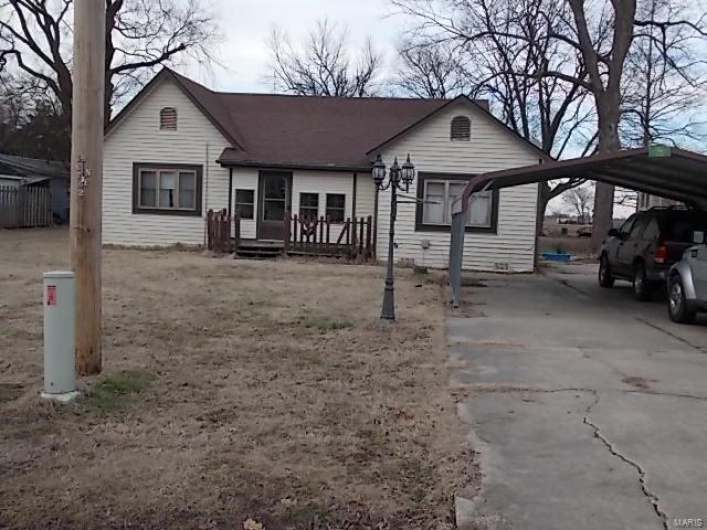 View of front of property with a carport