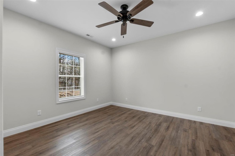 Spare room with ceiling fan and dark hardwood / wood-style flooring