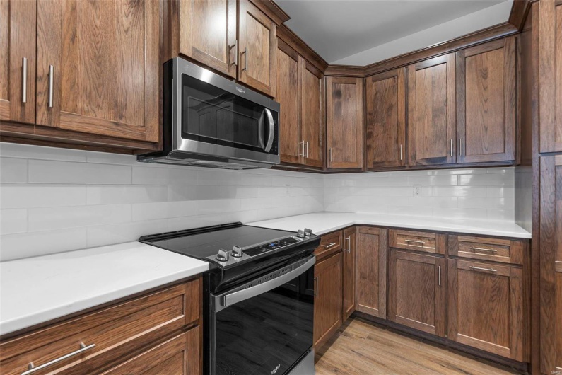 Kitchen with appliances with stainless steel finishes, decorative backsplash, and light wood-type flooring
