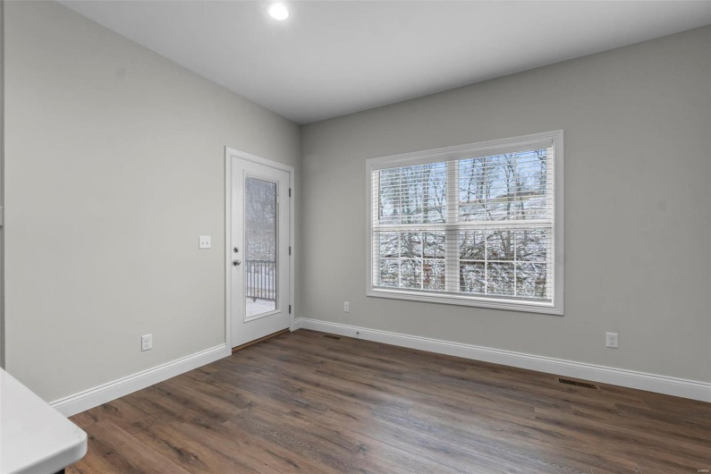 Empty room featuring dark wood-type flooring