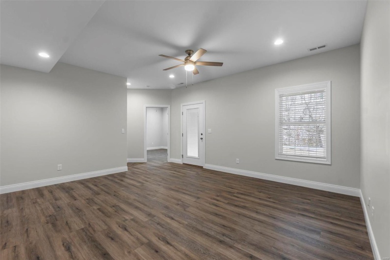 Unfurnished room featuring ceiling fan and dark wood-type flooring