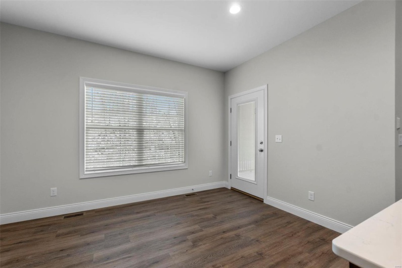 Empty room featuring dark wood-type flooring