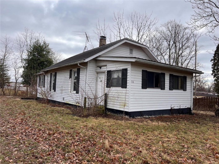 View of side of property with a lawn