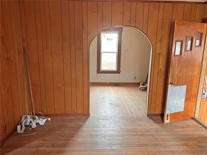 Hallway featuring wood-type flooring and wooden walls