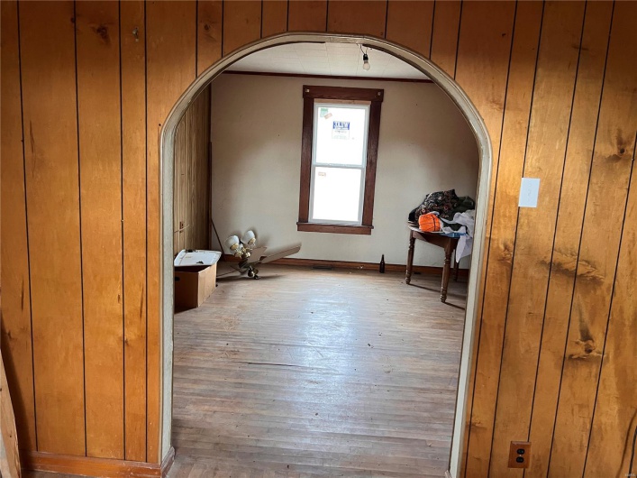 Bonus room featuring hardwood / wood-style floors and wooden walls