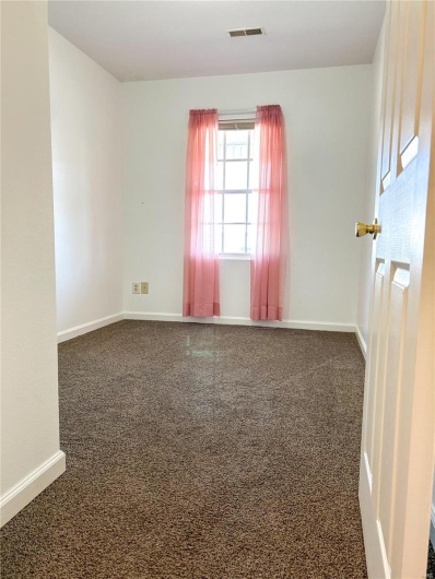 Spare room featuring baseboards, visible vents, and carpet flooring