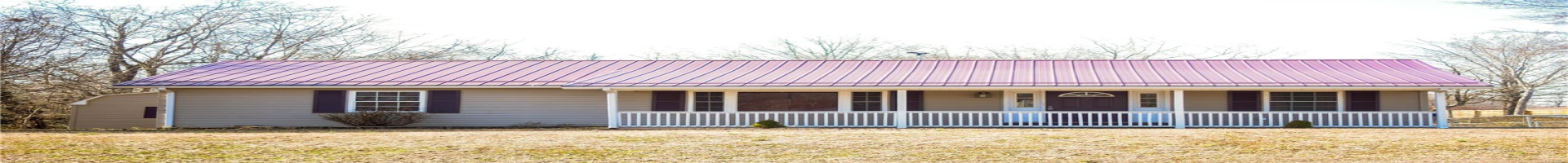 Residential For Sale Ranch-style home featuring covered porch, metal roof, and a front lawn