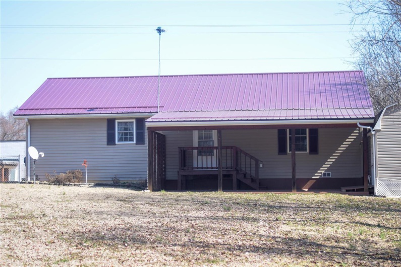 Back of property with metal roof