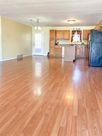 Kitchen with visible vents, open floor plan, white dishwasher, and freestanding refrigerator