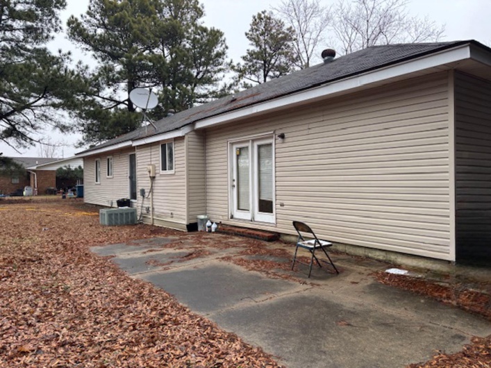 Back of house featuring cooling unit and a patio area