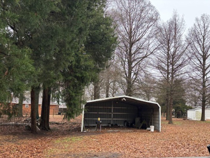 View of outbuilding with a carport