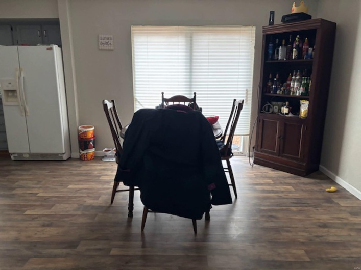 Dining space featuring dark wood-type flooring