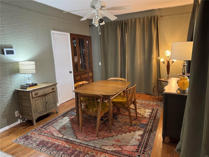 Dining space with ceiling fan and wood-type flooring