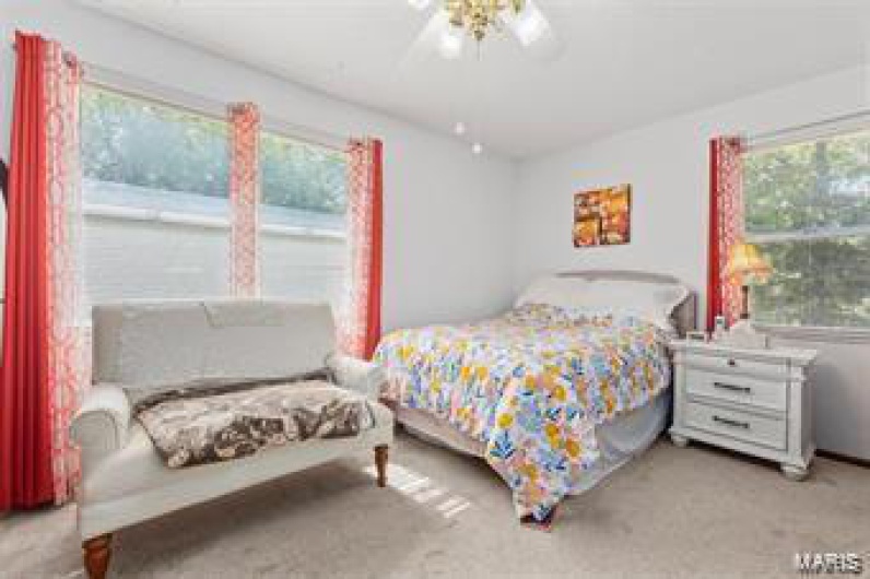 Bedroom with light carpet and ceiling fan