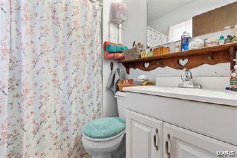 Bathroom with walk in shower, vanity, and toilet