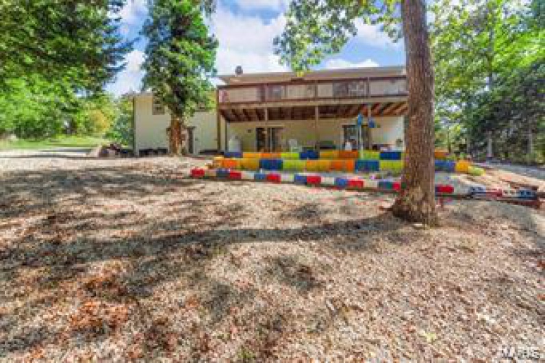 Back of house with a wooden deck