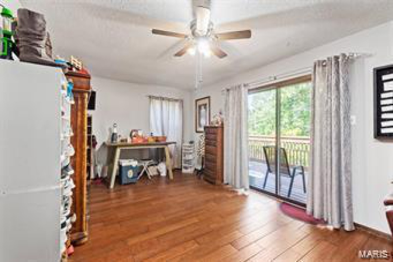 Miscellaneous room featuring dark wood-type flooring, ceiling fan, and a textured ceiling