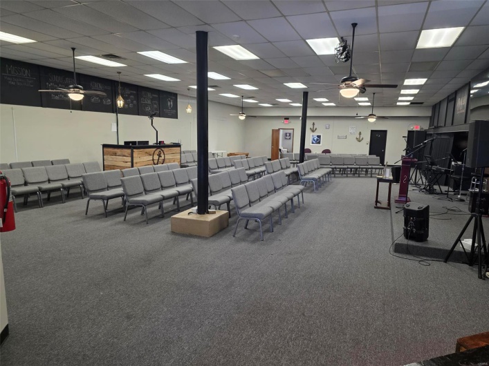 Miscellaneous room with carpet flooring, a ceiling fan, and a drop ceiling