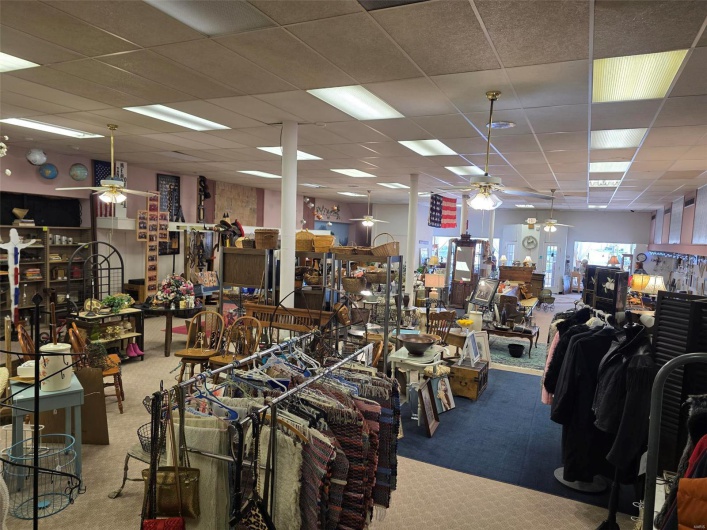 Miscellaneous room with a drop ceiling, ceiling fan, and carpet flooring