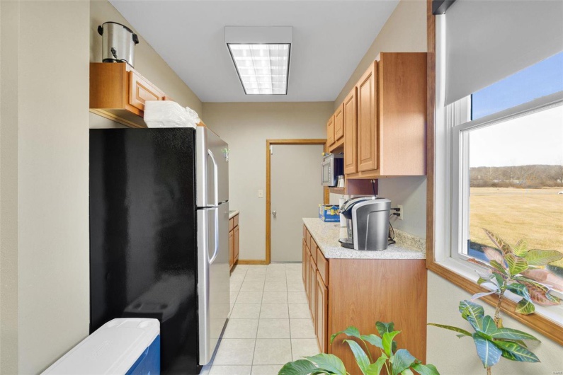 Kitchen featuring light tile patterned floors and stainless steel appliances