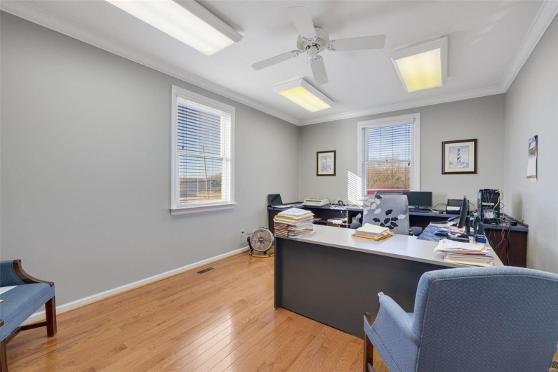 Home office with crown molding, light hardwood / wood-style floors, and ceiling fan