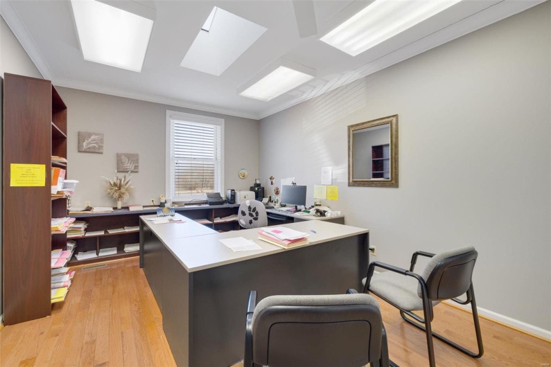 Office featuring crown molding and light hardwood / wood-style flooring