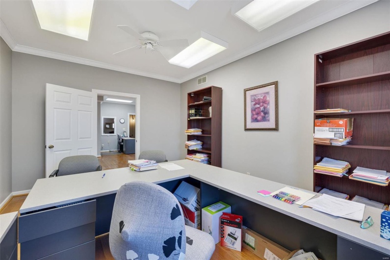 Office space featuring ornamental molding, hardwood / wood-style floors, and ceiling fan