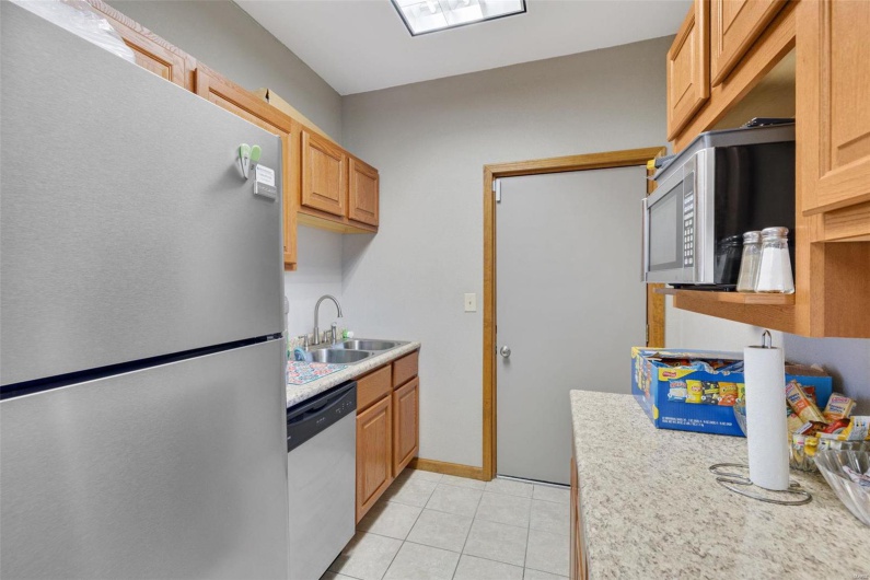 Kitchen featuring appliances with stainless steel finishes, sink, light brown cabinets, and light tile patterned floors