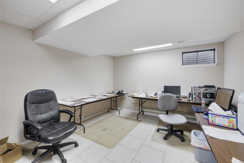Office space featuring light tile patterned floors and a drop ceiling