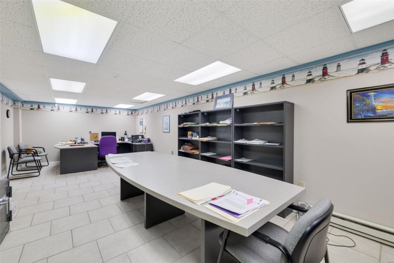 Office with a paneled ceiling and baseboard heating