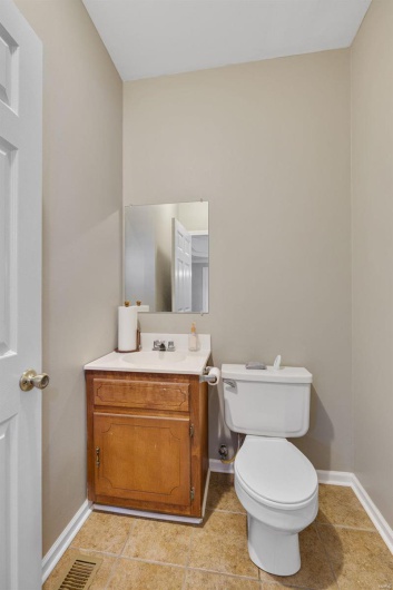 Bathroom with vanity, toilet, and tile patterned flooring
