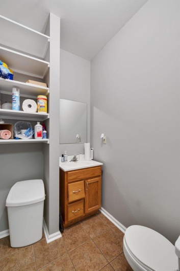 Bathroom with vanity, tile patterned floors, and toilet