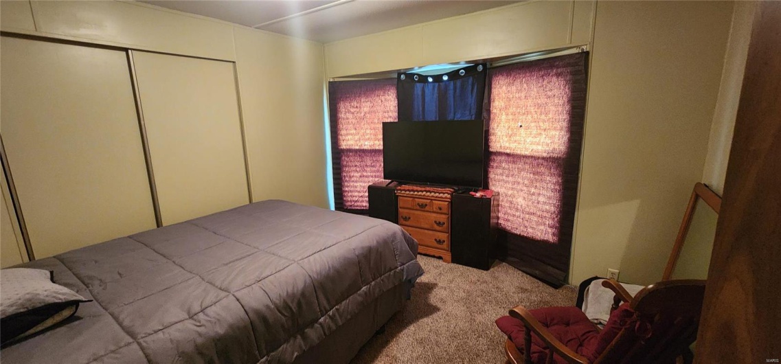Bedroom featuring a closet and light carpet