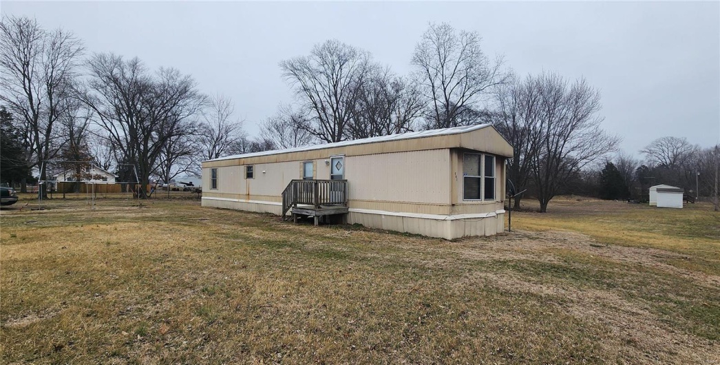 Back of house with a lawn