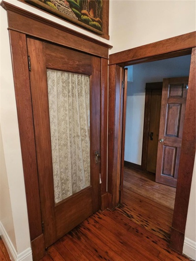 Corridor featuring dark wood-type flooring