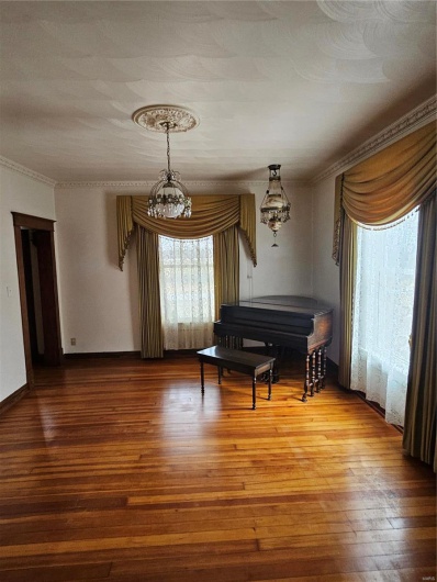 Unfurnished room featuring crown molding and hardwood / wood-style floors